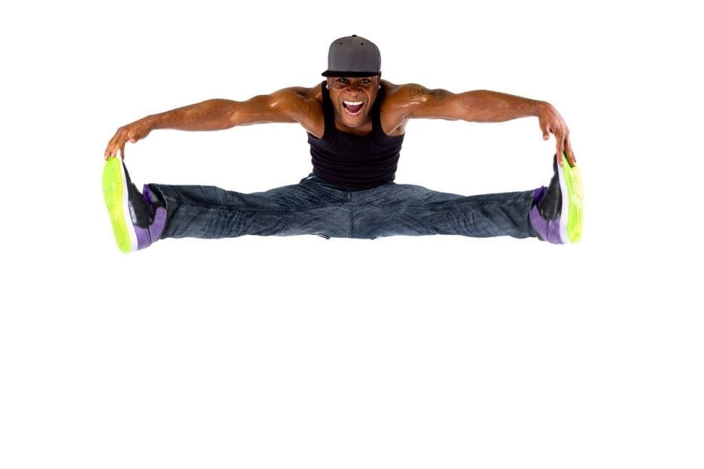 A man doing a split in the air.