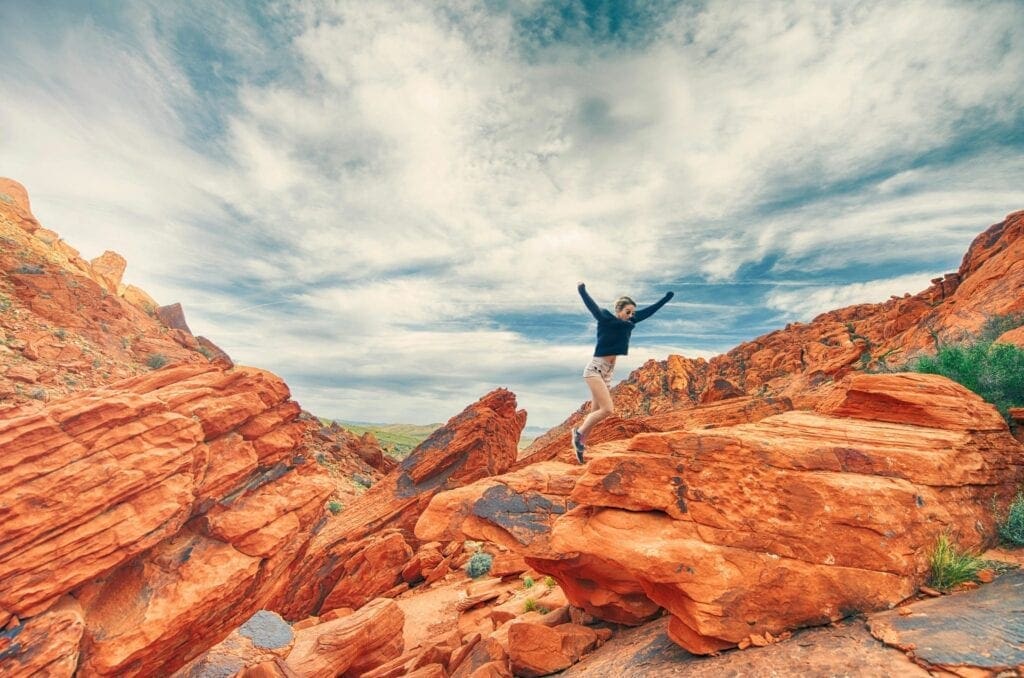 A person standing on top of rocks in the desert.