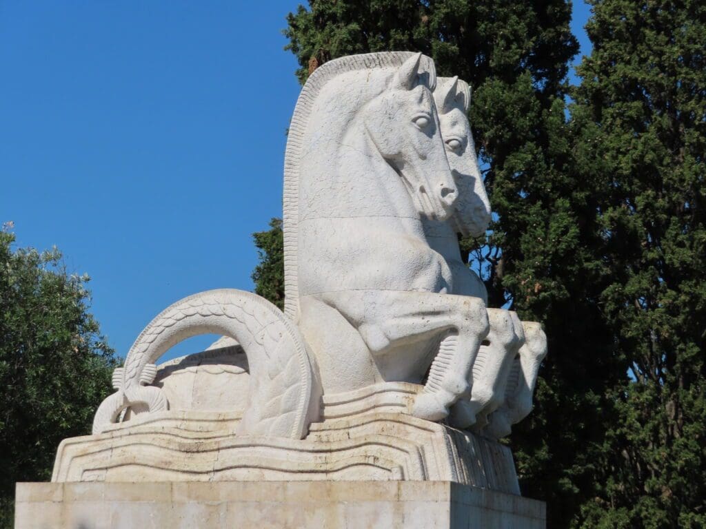 A statue of a horse is sitting on top of the water.