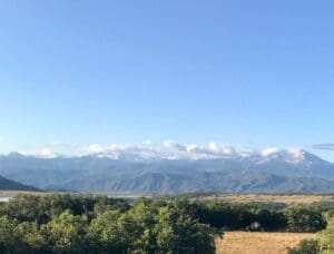 A view of the mountains from an open field.