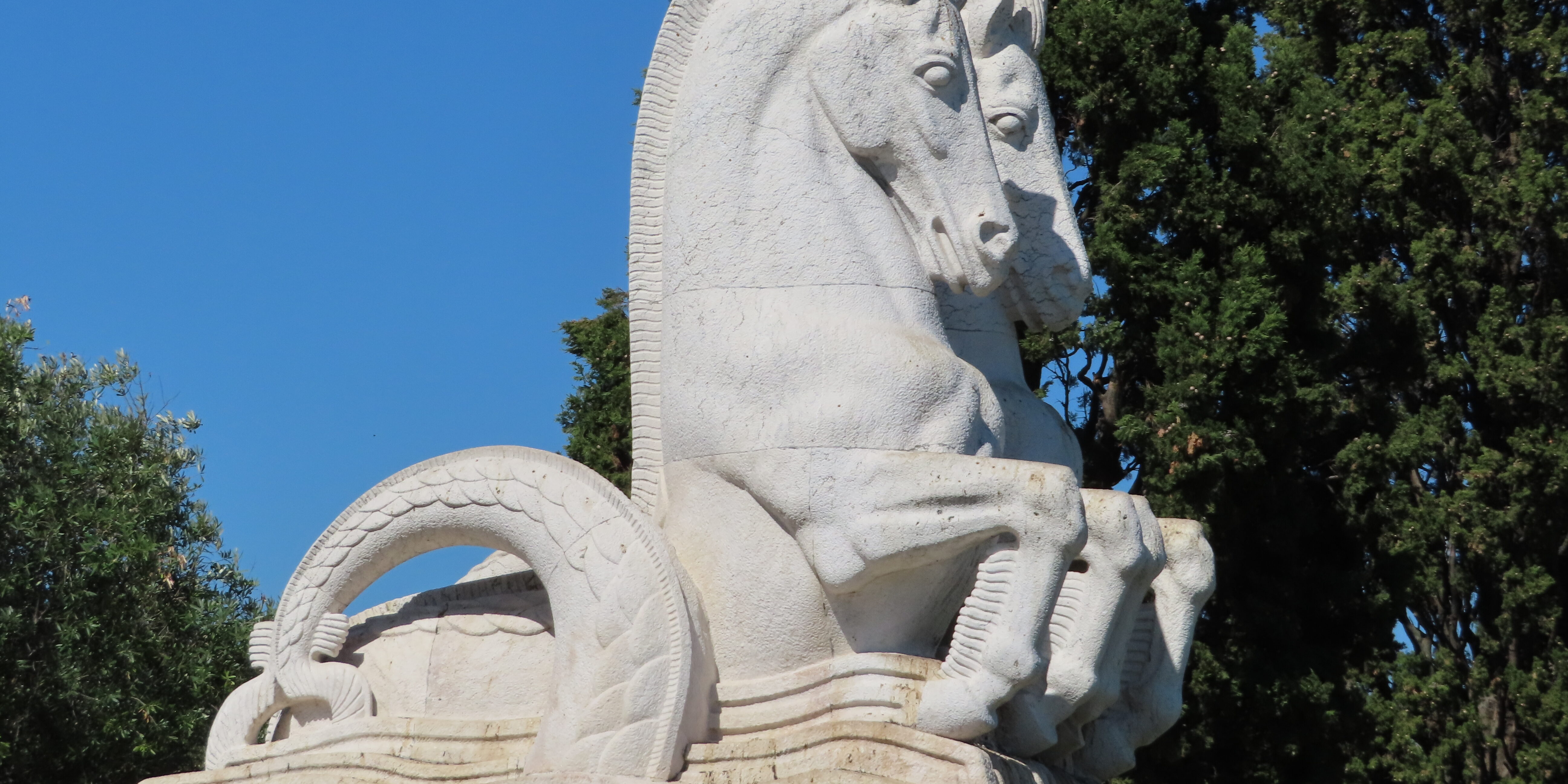 A statue of a horse is sitting on top of the water.