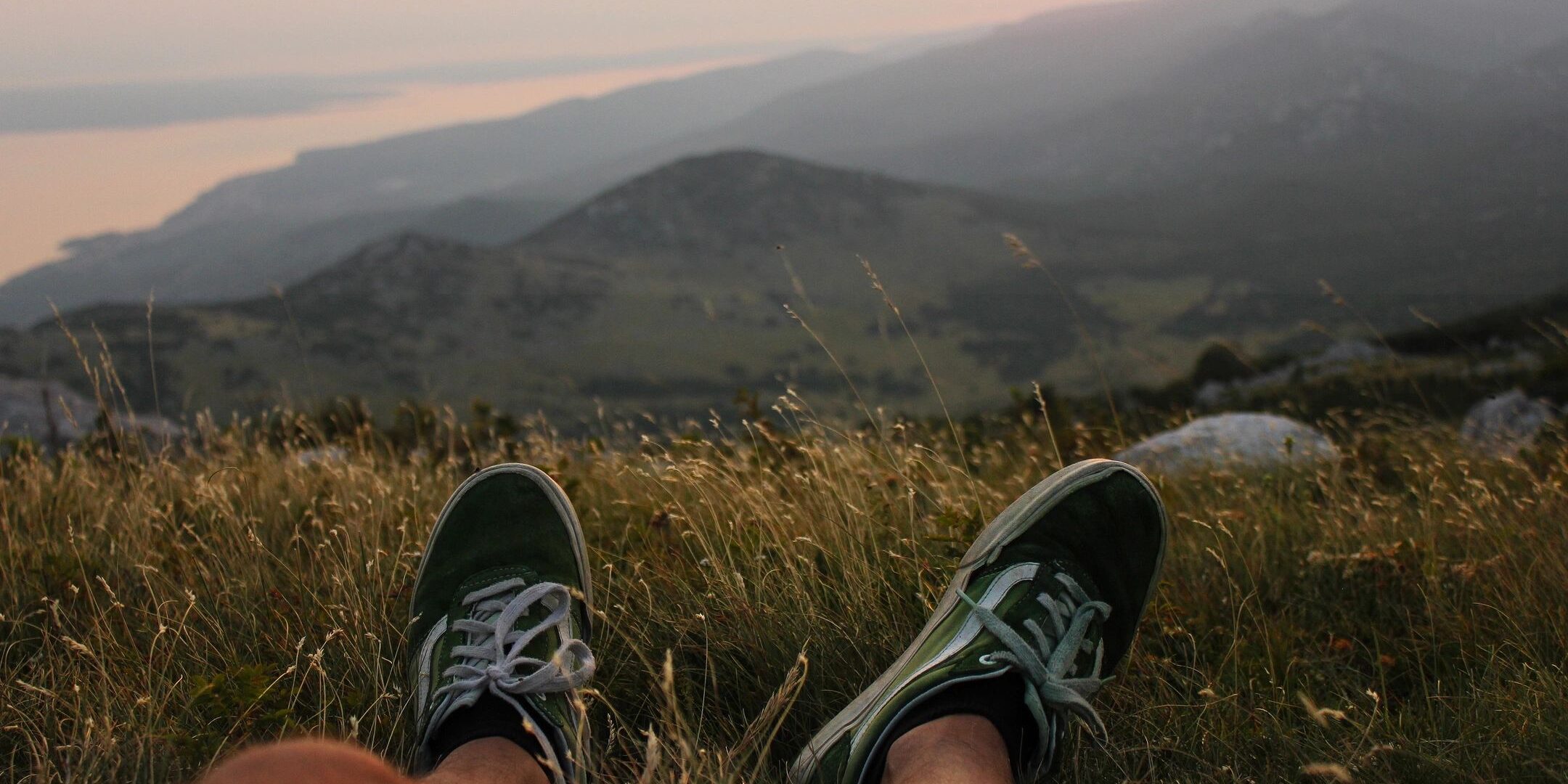 A person 's feet are shown on the ground.